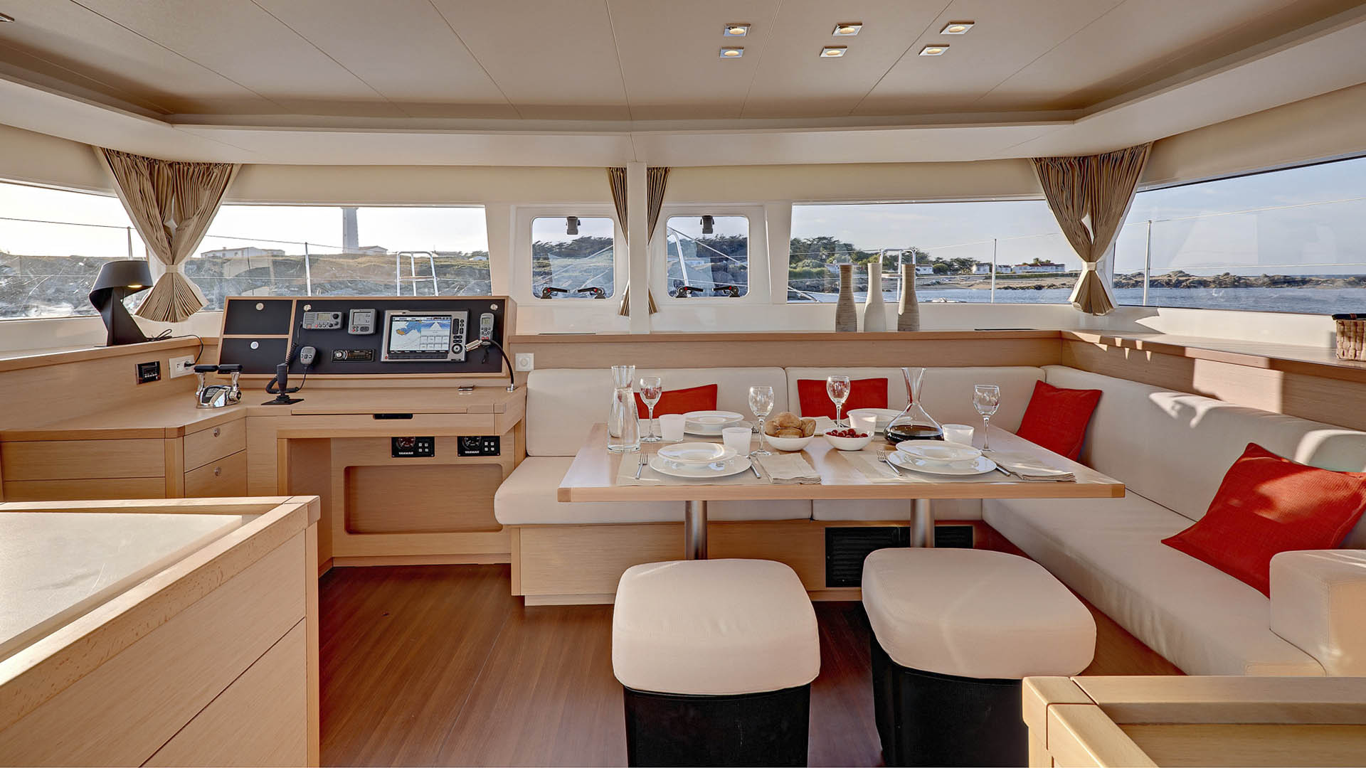 Panoramic salon with dining table set at dusk