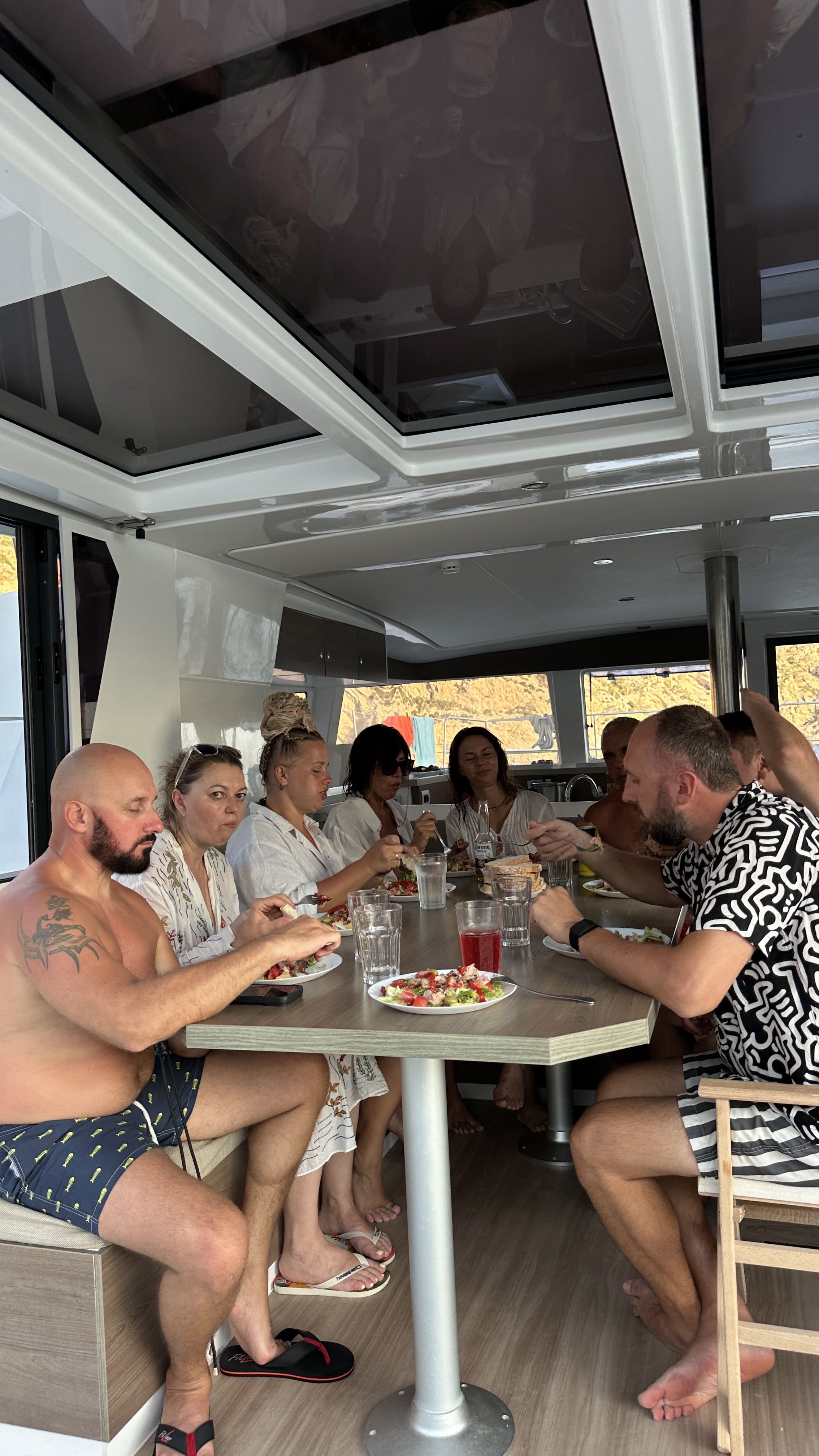 Crew sharing a meal on the catamaran